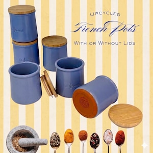 May include: Upcycled French pots in a light blue hue, some with wooden lids. The image also shows a mortar and pestle, and spoons filled with various spices. The text reads "UPCYCLED French Pots WITH OR WITHOUT LIDS."