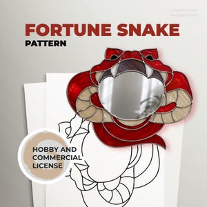May include: A red and cream-coloured snake-shaped mirror with the text "FORTUNE SNAKE PATTERN". The mirror has a circular reflective surface. The image also includes a "HOBBY AND COMMERCIAL LICENSE" badge.