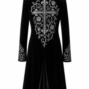 May include: A long black velvet coat with detailed silver embroidery. The back showcases a large cross design with floral and vine patterns. Silver embroidered accents adorn the sleeves and collar. A gothic-style garment.