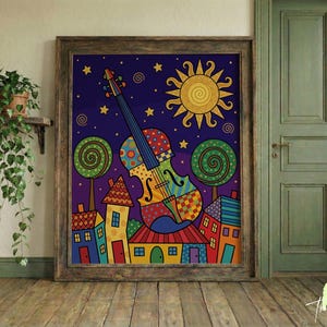May include: A framed art print featuring a colorful violin against a night sky with stars and a sun. The artwork includes whimsical houses, trees, and a vibrant color palette, creating a cheerful and artistic scene.