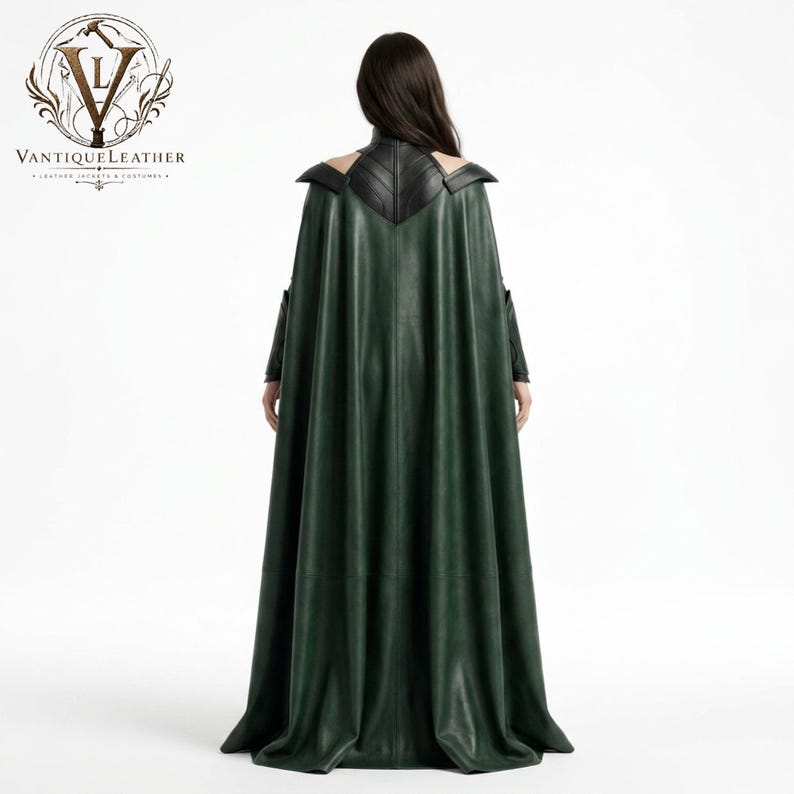 May include: A floor-length dark green leather cape featuring a structured black leather collar and shoulder panels. The garment displays a V-shaped back yoke design with visible stitching. The VANTIQUELEATHER logo is visible in the top left corner.