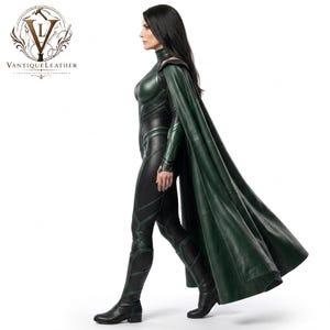 May include: A black and dark green leather bodysuit featuring a high collar, long sleeves, and integrated shoulder armor. The costume includes a long, flowing dark green leather cape and matching black leather boots with green panel detailing.
