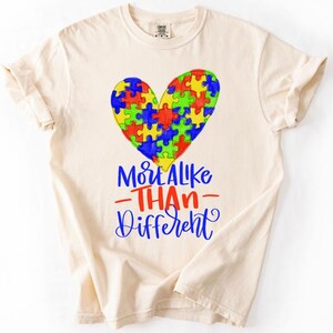 May include: A set of three ceramic mugs with a speckled, matte finish. The mugs are in shades of cream, light gray, and dark gray. Each mug has a simple, minimalist design and a rounded handle.