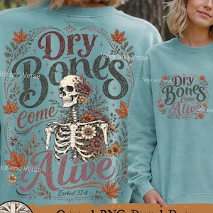 May include: A teal crewneck sweatshirt featuring a graphic print of a skeleton torso adorned with colorful flowers and autumn leaves. The text reads Dry Bones Come Alive with the reference Ezekiel 37:4 in a decorative script and block font style.