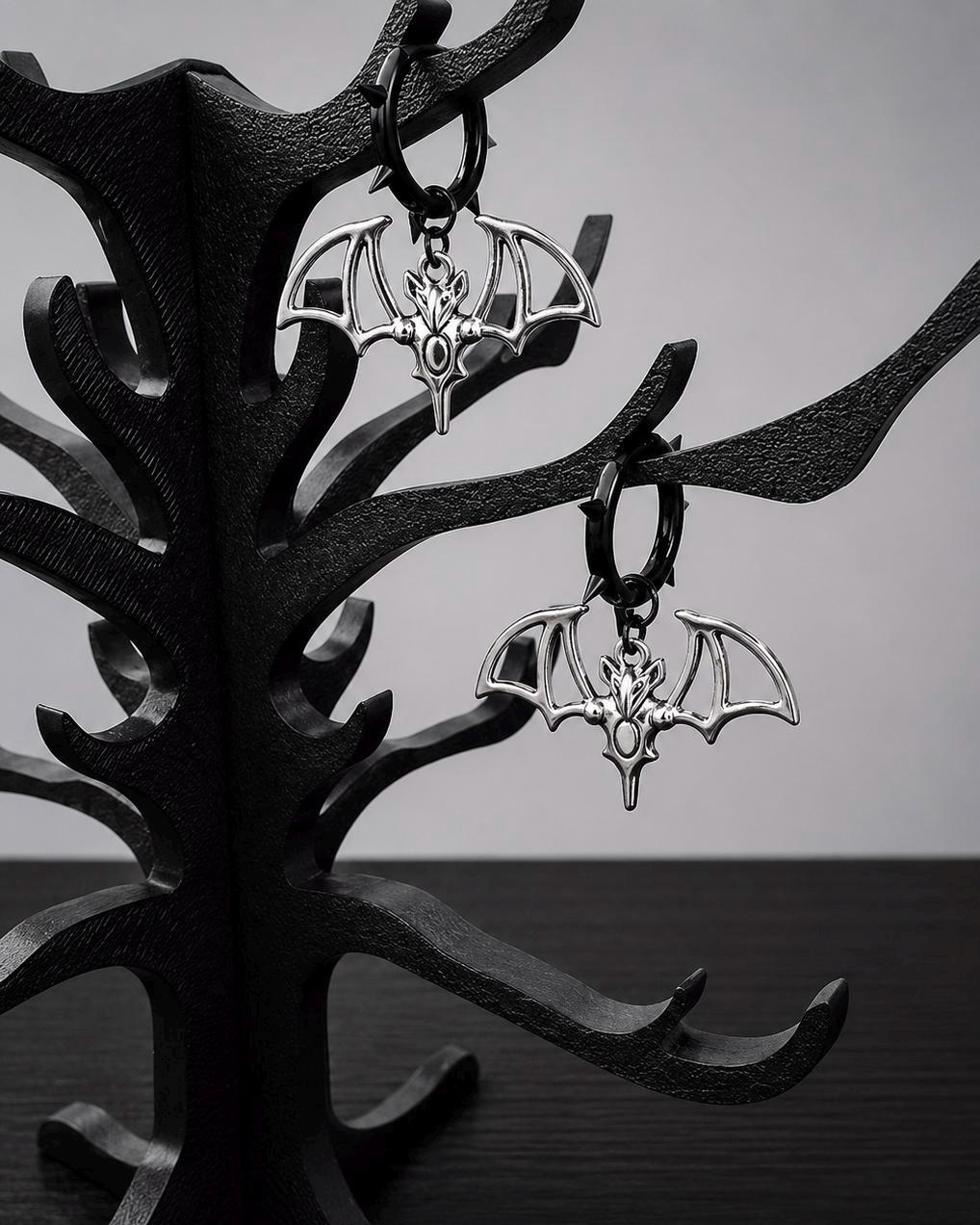 Black spiked hoop earrings with silver tone bat charms