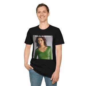 May include: Black t-shirt featuring a rectangular image of a woman in a green v-neck top. The image has the text "Erin Go Bragh-less" at the top. The t-shirt is worn by a person.