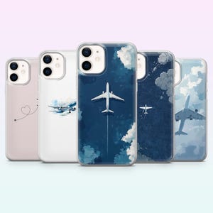 Puede incluir: Una colección de cinco fundas para teléfono con diseños de aviones. Las fundas presentan varias ilustraciones, incluyendo una línea punteada en forma de corazón, un avión en vuelo y vistas aéreas de aviones sobre fondos azules y nublados.