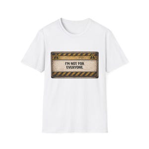 May include: White t-shirt with a rectangular graphic. The graphic features a warning sign design with black and yellow stripes and the text "I'M NOT FOR EVERYONE" in a bold, sans-serif font. The shirt is a classic crew neck style.