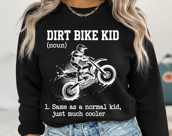 May include: Black sweatshirt with the text "DIRT BIKE KID (noun)" above a graphic of a motocross rider on a dirt bike. Below the graphic is the text "1. Same as a normal kid, just much cooler."