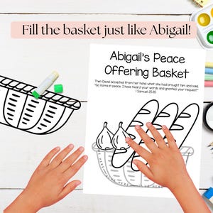 May include: Black and white line drawing of a basket with the text "Fill the basket just like Abigail!" and "Abigail's Peace Offering Basket". The image includes illustrations of bread and figs, with hands interacting with the drawing.