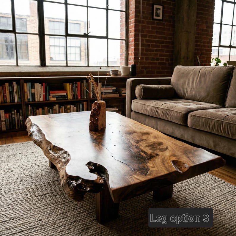 May include: A large, natural-edge wooden coffee table with a rich, dark finish. The table features a unique, organic shape and is supported by four sturdy legs. The text "Leg option 3" is visible on the bottom right.