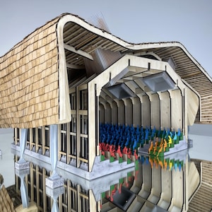 May include: A detailed architectural model of a building with a curved, shingled roof. The model features a wooden frame, a staircase, and rows of miniature figures in various colours, suggesting an auditorium or theatre.