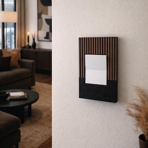 May include: A modern wall-mounted light switch with a rectangular design. The switch features a dark wood grain frame with vertical slats, a black textured base, and a white square switch. The switch is mounted on a white wall.