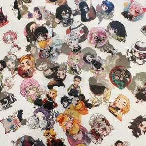 May include: A collection of numerous small, colorful stickers featuring various chibi-style anime characters with diverse hair colors, outfits, and expressions, scattered across a plain white surface in a dense, overlapping arrangement.