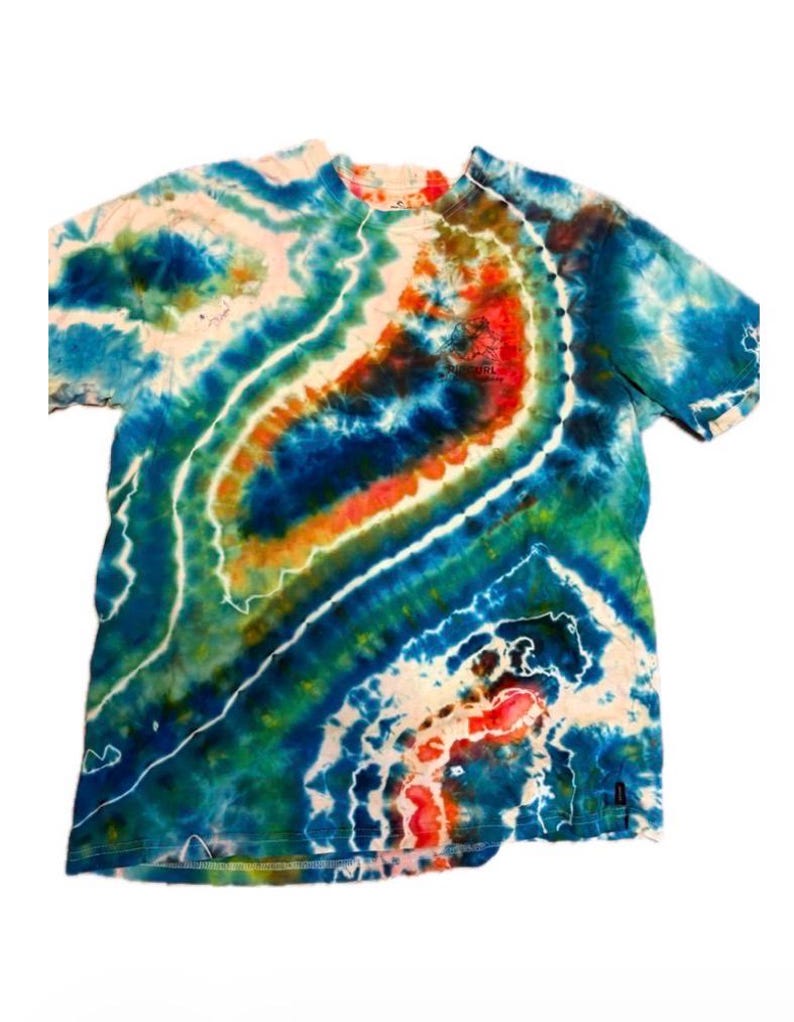 May include: A tie-dye t-shirt with a vibrant swirl pattern in shades of blue, green, orange, and white. The shirt has a crew neck and short sleeves. The fabric appears to be cotton.