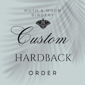 May include: A light teal background with the text "Moth & Moon Bindery" above a black moth illustration. Below the moth is the word "Custom" in cursive, followed by "HARDBACK" and "ORDER" in a serif font.