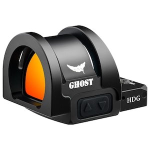 May include: Black optic sight with the word "GHOST" in white. The sight has an orange lens and a white leaf-like logo. The base has the letters "HDG" and two arrow buttons. A modern, high-tech accessory.