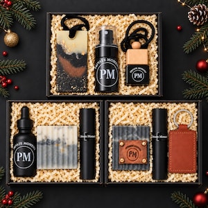 May include: Three black gift boxes filled with shredded paper containing various items. Items include black spray bottles, dropper bottles, and tubes labeled Private Moment PM, a rectangular resin piece, a wooden diffuser, and a leather keychain.