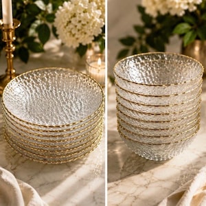 May include: A stack of clear glass plates and a stack of clear glass bowls, both featuring a textured, dimpled surface and a thin gold-colored rim. The glassware has a reflective, crystalline appearance with a distinct pattern of small indentations.