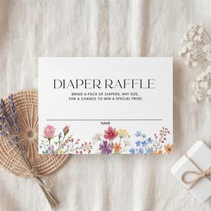 Collection of matching baby shower stationery designs including an invitation, diaper raffle ticket, books for baby card, and thank you note, all featuring a watercolor wildflower theme.