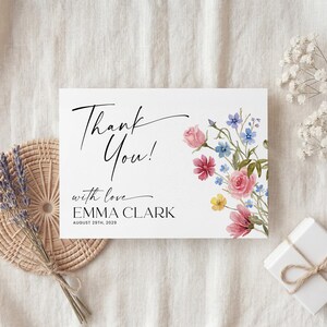 Collection of matching baby shower stationery designs including an invitation, diaper raffle ticket, books for baby card, and thank you note, all featuring a watercolor wildflower theme.