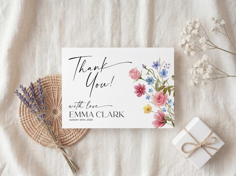 Collection of matching baby shower stationery designs including an invitation, diaper raffle ticket, books for baby card, and thank you note, all featuring a watercolor wildflower theme.