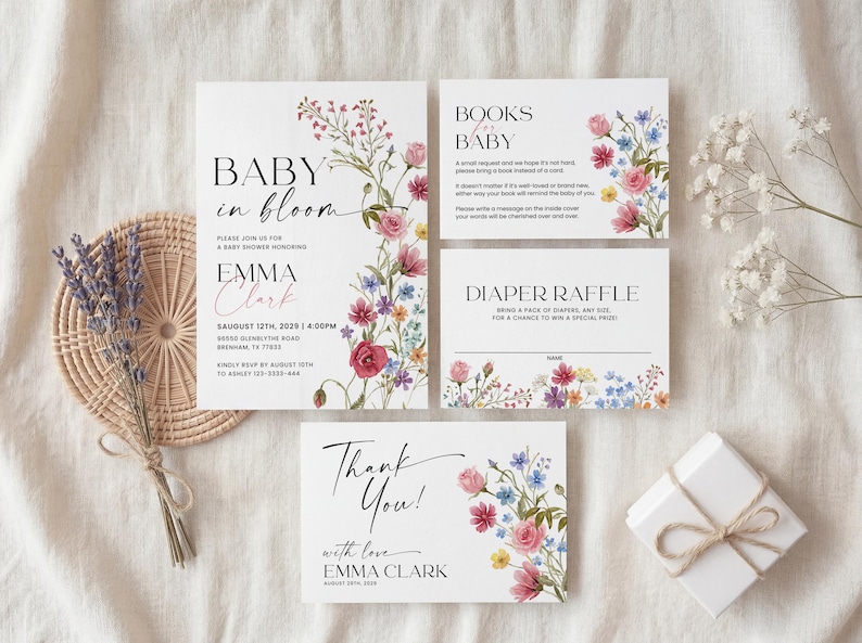 Collection of matching baby shower stationery designs including an invitation, diaper raffle ticket, books for baby card, and thank you note, all featuring a watercolor wildflower theme.