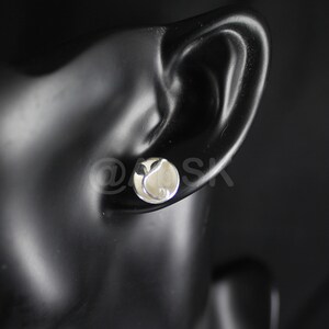 May include: Silver stud earrings with a small, round, white stone in the center.