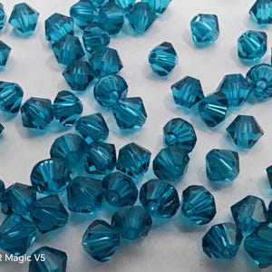Perline Swarovski Crystal BICONE 5328 5301 INDICOLITE - Disponibili in 3 mm, 4 mm, 5 mm e 6 mm (scegli quantità e misure)