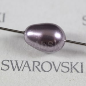 May include: A single, pearlescent, light purple Swarovski bead on a silver wire.