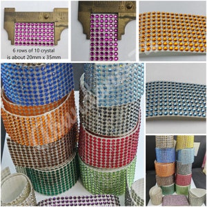 May include: Assortment of colorful rhinestone trim rolls, each roll is approximately 20mm wide and 35mm long. The trim is made of small, round rhinestones that are set in a clear adhesive backing. The trim is available in a variety of colors, including blue, green, red, orange, and purple.