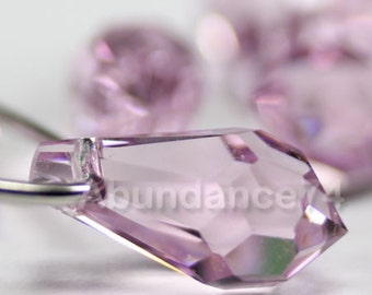 May include: A close-up of a light purple crystal teardrop pendant. The pendant is faceted and has a shiny, reflective surface.