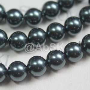 May include: A strand of dark gray pearl beads. The pearls are round and have a smooth, glossy finish.