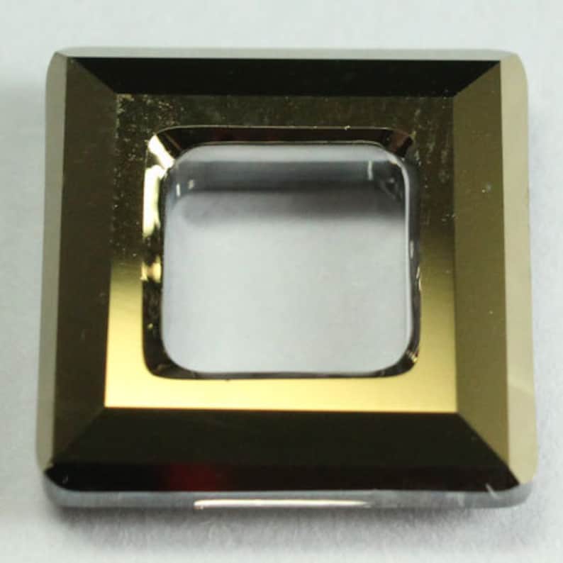 May include: A square-shaped, gold-toned metal frame with a clear glass center. The frame has a beveled edge and a polished finish.