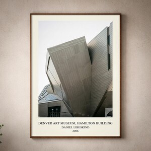 May include: A framed architectural print featuring the Denver Art Museum, Hamilton Building, designed by Daniel Libeskind in 2006. The image displays the angular, metallic facade of the building with sharp geometric lines and a light gray sky.