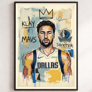 May include: A framed art print featuring a stylised portrait of a basketball player in a white Dallas jersey. The background includes abstract blue and yellow brushstrokes, a crown illustration, the text Klay, Mavs, Shooter, and the Dallas Mavericks logo.