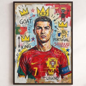 May include: A framed wall art print featuring a stylized portrait of Cristiano Ronaldo in a red Portugal soccer jersey. The artwork includes graffiti-style elements, yellow crowns, the text GOAT, CR7, PORTUGAL, SIIIIUUUU, KING, and LEGEND.