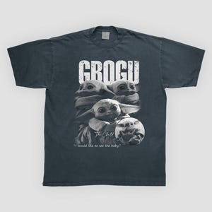 May include: Dark gray t-shirt featuring a graphic of Grogu, also known as The Child, from The Mandalorian. The design includes multiple images of Grogu with the word "GROGU" above and the text "I would like to see the baby." below.