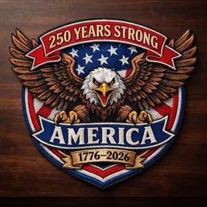 May include: A circular embroidered patch featuring a bald eagle with spread wings centered over a red, white, and blue American flag design. The text 250 YEARS STRONG appears at the top, with AMERICA and 1776-2026 on banners below.