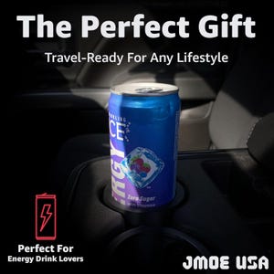 May include: A blue and silver can of Sparkling Ice Energy drink in a car cup holder. The can features a berry graphic and the text "Zero Sugar with Vitamins." The image includes the text "The Perfect Gift" and "Travel-Ready For Any Lifestyle."