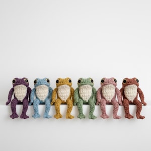 May include: A set of three ceramic mugs with a speckled, matte finish. The mugs are in shades of cream, light gray, and dark gray. Each mug has a simple, minimalist design and a rounded handle. Perfect for coffee or tea.