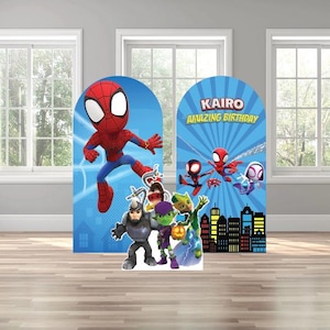 May include: Two arch-shaped cardboard cutouts featuring Spider-Man and other characters. The left cutout shows Spider-Man in a dynamic pose against a blue background. The right cutout has the text "KAIRO AMAZING BIRTHDAY" and more characters.