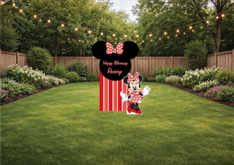 May include: A Minnie Mouse-themed birthday yard decoration. The decoration features a black Minnie Mouse head with a red bow, a red and white striped base, and a Minnie Mouse cutout. The words "Happy Birthday Avery" are on the decoration.