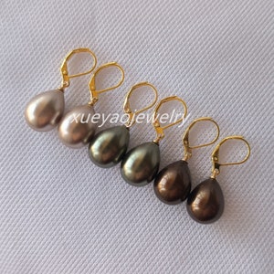 May include: A set of four teardrop-shaped pearl earrings with gold leverback closures. The pearls are in shades of brown, grey, and green.