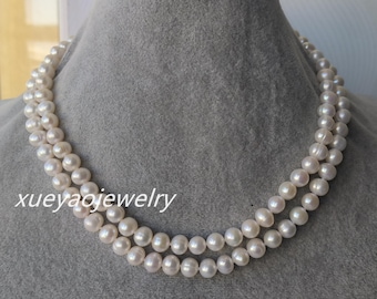 May include: A double strand pearl necklace with white pearls. The necklace is on a white background.