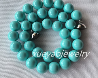 May include: A turquoise blue beaded necklace with silver clasps. The necklace is made of round beads and is approximately 18 inches long.