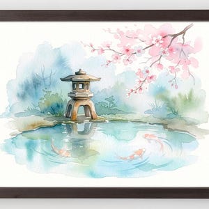 May include: Watercolor painting of a Japanese garden scene in a dark brown frame. The artwork depicts a stone lantern, a pond with koi fish, and a cherry blossom branch with pink flowers. The background features soft blue and green hues.