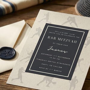 May include: An invitation for a Bar Mitzvah with a cream-colored background and a dark gray border. The invitation includes the text "Bar Mitzvah" and the name "James". An envelope with a wax seal, a kippah, and twine are also present.