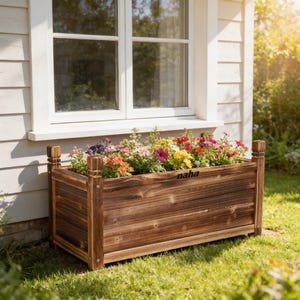 Puede incluir: Una jardinera rectangular de madera llena de flores coloridas, colocada debajo de una ventana blanca. La jardinera tiene un acabado marrón oscuro y la palabra "naha" es visible en el lateral. La jardinera está sobre un césped.