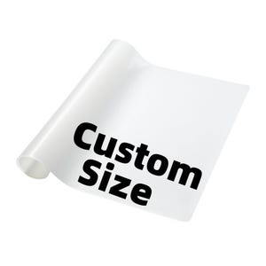 May include: A rolled-up, white sheet of material with the words "Custom Size" printed in bold black letters. The sheet is slightly translucent, and the text is clearly visible against the white background.